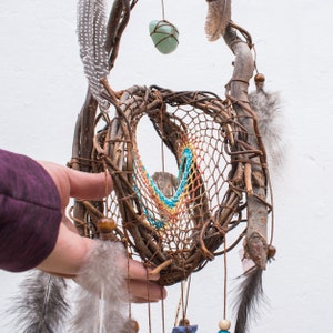 three dimensional brown dream catcher with precious stones