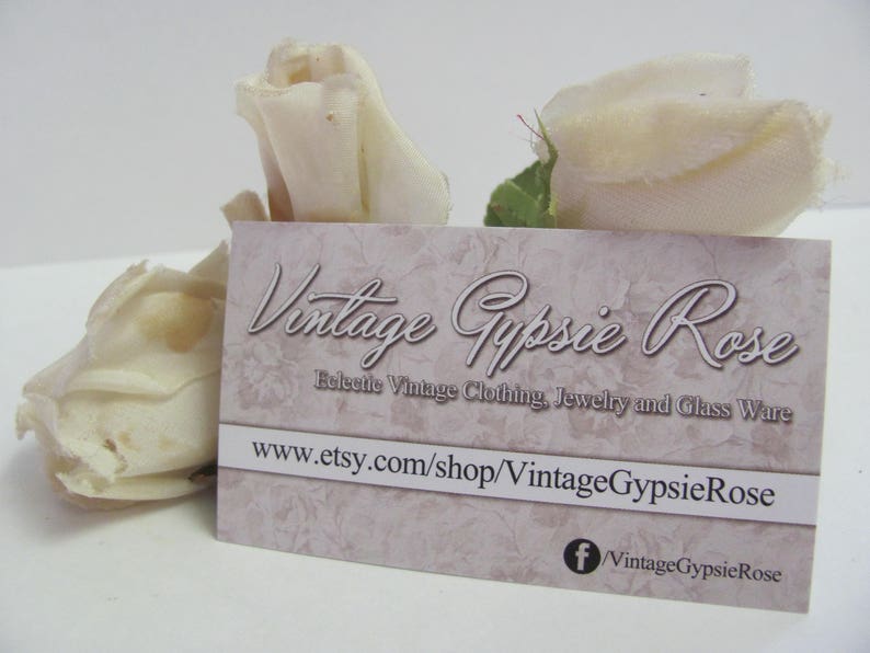May include: A business card with the text "Vintage Gypsie Rose" and the website address "www.etsy.com/shop/VintageGypsieRose". The card is decorated with a floral pattern and has a Facebook icon with the text "VintageGypsieRose".