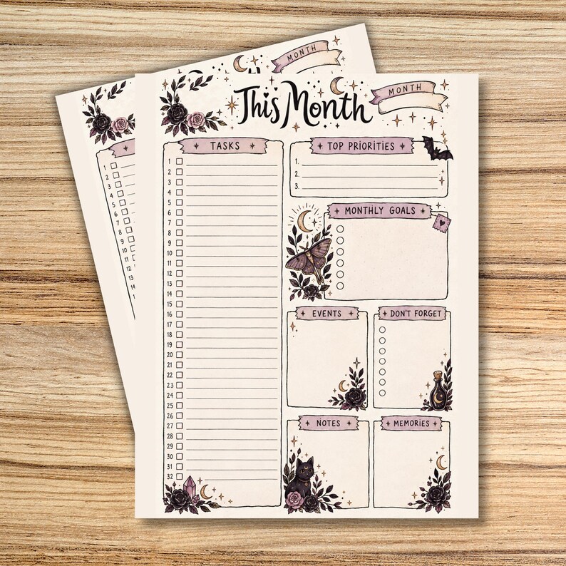 Spooky-cute printable monthly planner pages displayed on a wooden background, featuring black cats, bats, roses, moons, stars, crystals, and a moth. The main page includes sections for tasks, top priorities, monthly goals, events, reminders, notes, and memories.