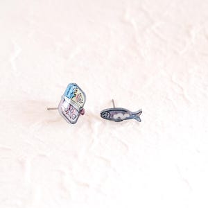 a pair of fish pins sitting on top of a white surface
