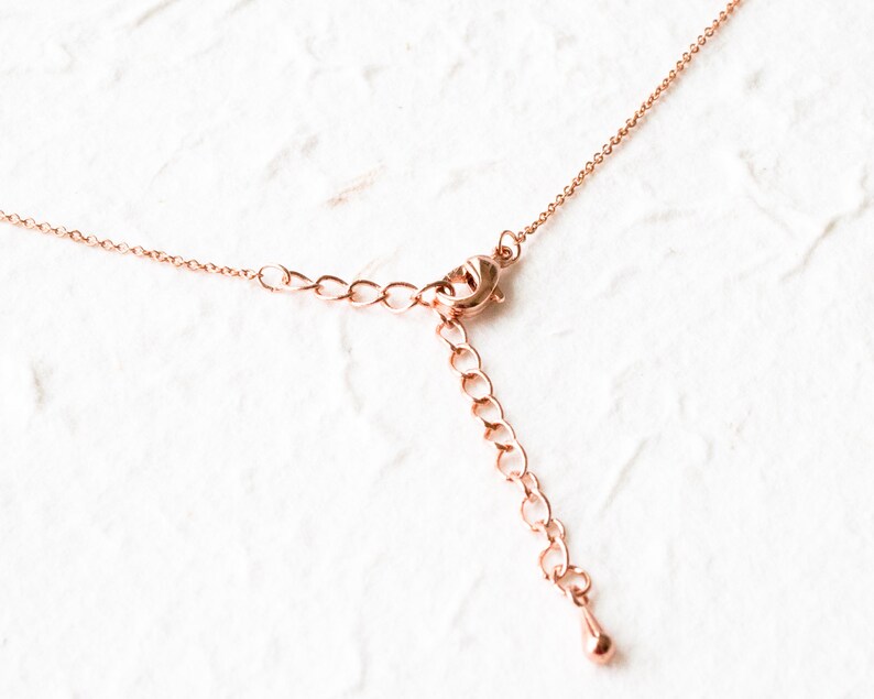 May include: A rose gold chain necklace with a lobster clasp and an extension chain.