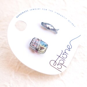 a couple of pins sitting on top of a white plate