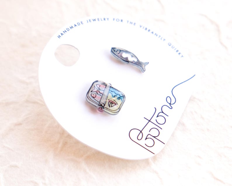 a couple of pins sitting on top of a white plate