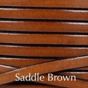 May include: Close-up of a spool of brown leather cord. The cord is approximately 3mm wide and has a saddle brown color.
