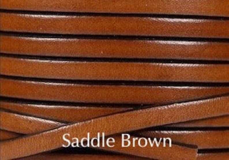 May include: Close-up of a spool of brown leather cord. The cord is approximately 3mm wide and has a saddle brown color.