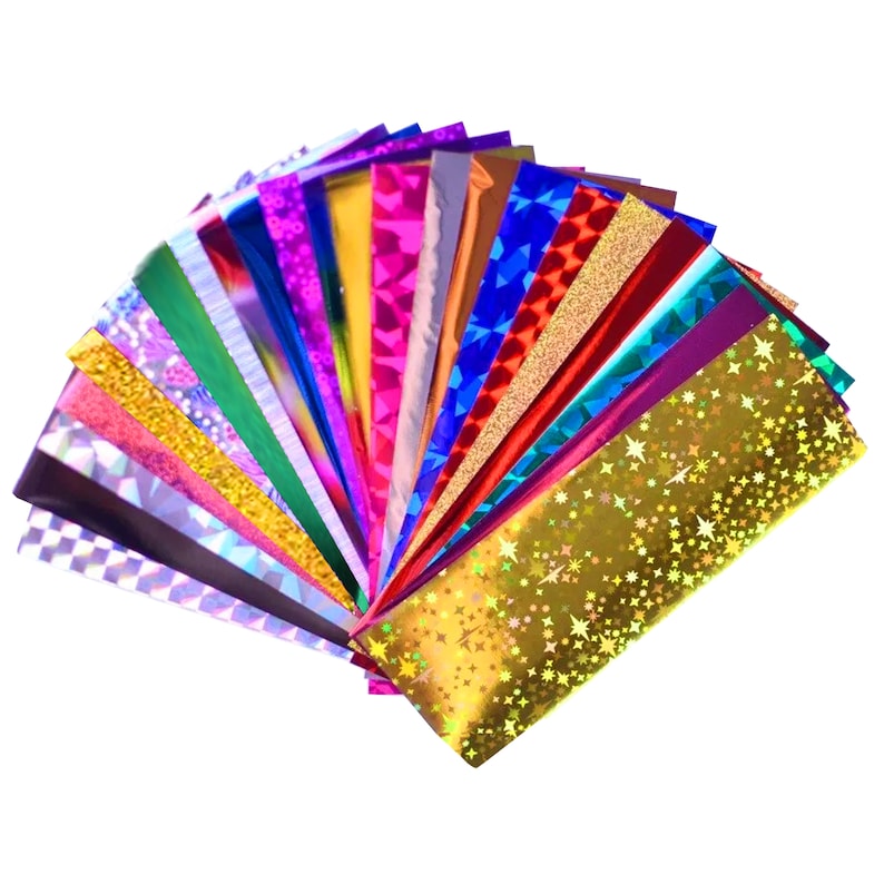 May include: A fan of iridescent holographic paper sheets in various colors and patterns, including gold, red, blue, green, and purple.