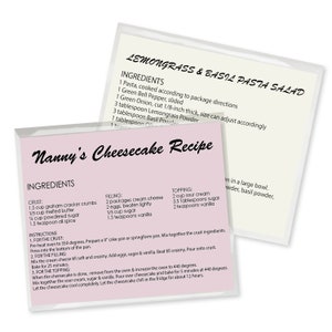 May include: A pink and white recipe card with the title "Nanny's Cheesecake Recipe" and a list of ingredients for the crust, filling, and topping. The recipe includes measurements in cups and teaspoons.