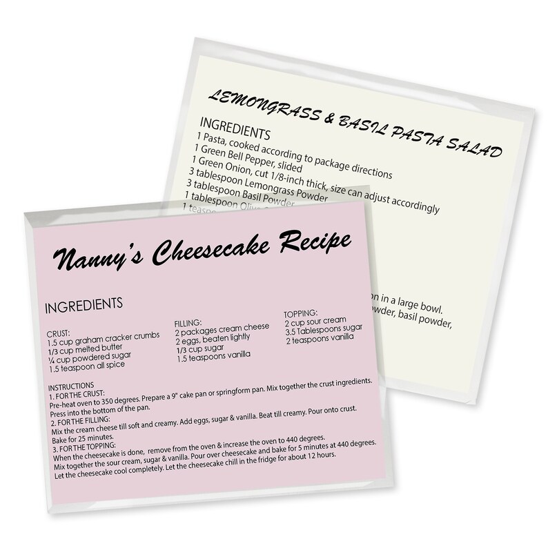 May include: A pink and white recipe card with the title "Nanny's Cheesecake Recipe" and a list of ingredients for the crust, filling, and topping. The recipe includes measurements in cups and teaspoons.