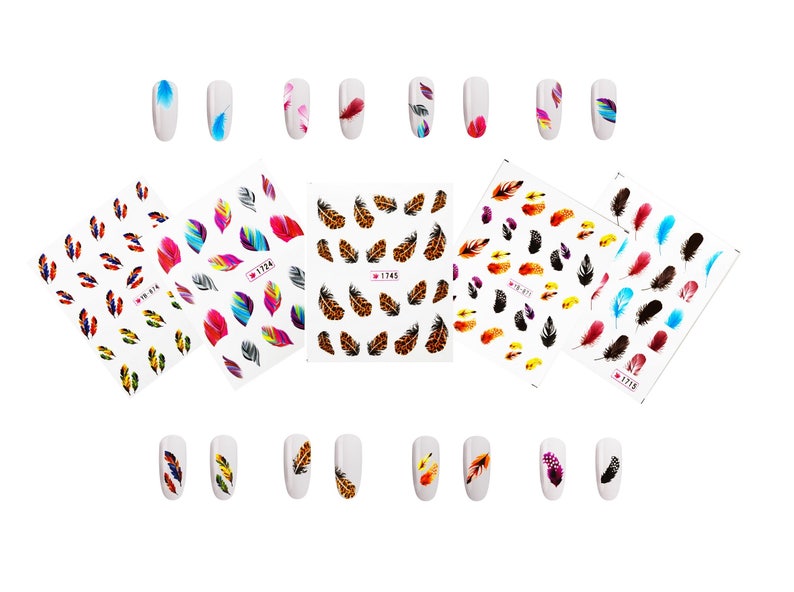 May include: Nail art stickers featuring colorful feather designs. The image shows several sheets of nail decals with various feather patterns in shades of blue, red, yellow, and brown. Some nails are also decorated with feather designs.