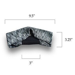 May include: A black and white patterned headband with a black elastic band in the middle. The headband measures 9.5 inches long and 3.25 inches wide.