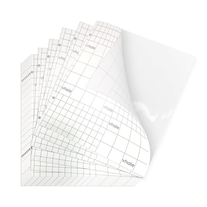 May include: A stack of white adhesive sheets with a grid pattern and the word "whale" printed on each sheet. The sheets are designed for crafting and are perfect for creating custom designs.