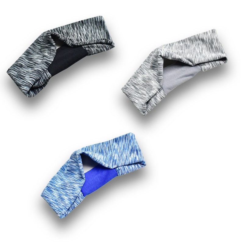 May include: Three headbands in different colors and patterns. One is gray with black, one is gray with gray, and one is blue with blue.
