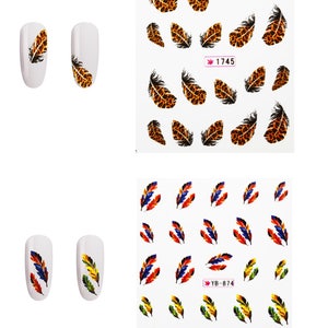 May include: Nail art stickers featuring feather designs. One sheet has leopard print feathers, the other has colorful feathers. Two white painted nails with feather designs are also shown. The sheet with leopard print feathers has the number "1745".