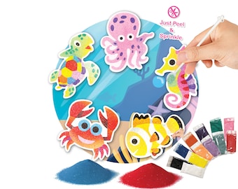 May include: A set of colorful sand art kits featuring sea creatures like an octopus, turtle, seahorse, crab, and fish. Each creature is outlined and ready to be filled with colored sand. The kit includes a small plastic tool for applying the sand and a variety of colored sand containers.