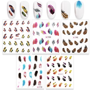 May include: Nail art stickers featuring colorful feather designs. The stickers include various styles, such as watercolor, leopard print, and solid colors. Some sheets have the numbers "YB-874", "1724", "1745", "1715", and "YB-871".