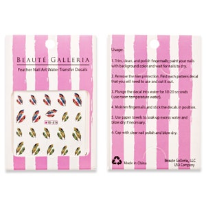 May include: A package of nail art water transfer decals featuring a feather design. The decals include various colors like blue, red, and gold. The package has the text "BEAUT&Eacute; GALLERIA" and instructions for use.