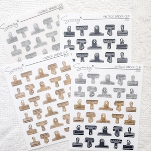 May include: Four sheets of sticker paper with various binder clip designs. The stickers are in four different colours: silver, black, gold, and brown. Each sheet has the text "Sancy Stickers Co." and "Vintage Binder Clip JF029".