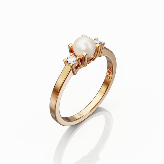 Engagement ring with 2024 pearl side stones