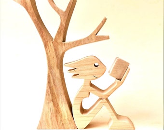 a woman a book a tree; original wood sculpture 2comma5d