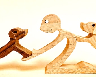 a man two labradors; scrolled wood sculpture