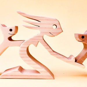 a woman two cats; wood sculpture