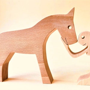 a woman and a horse; fretwork wood sculpture