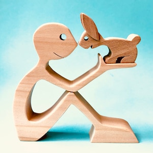a man a rabbit; wood carving