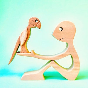a man a parrot; wood sculpture 2virgule5d