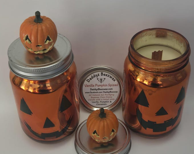 Vanilla Pumpkin Spized: 15 oz Scented All Natural Beeswax Coco Creme wood wick candle in orange glass pumpkin jar with pumpkin head lid.