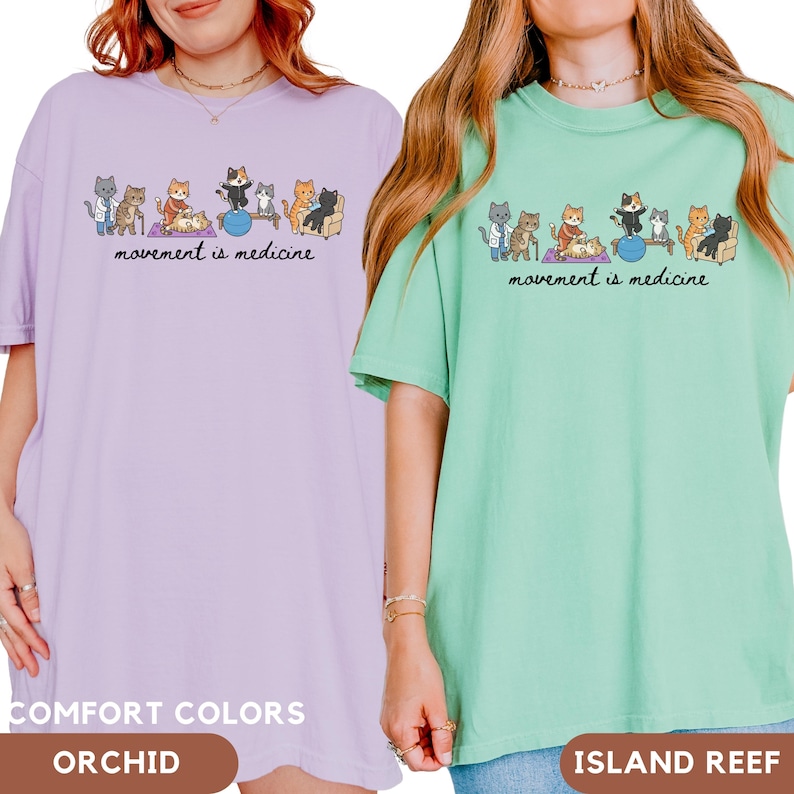May include: Two short-sleeved t-shirts in orchid and island reef colors. Each shirt features a graphic of cartoon cats performing physical therapy exercises with the text "movement is medicine" printed in black script below the illustrations.