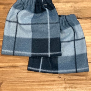 May include: Two blue and black plaid fleece leg warmers with elastic tops.