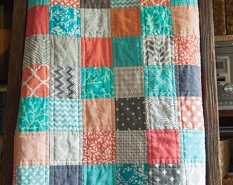 Modern baby patchwork quilt with coral, blue, and gray colors