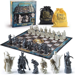 May include: A Lord of the Rings chess set featuring 32 detailed character pieces in black and white. The set includes a chessboard, storage bags, and a decorative box. The box and bags display the text "The Lord of the Rings: Battle for Middle Earth Chess Set."