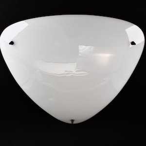 May include: White ceiling light fitting with a rounded, triangular shape.