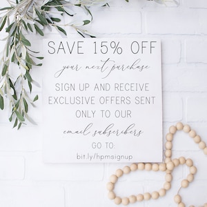 May include: White sign with black text that reads "SAVE 15% OFF your next purchase SIGN UP AND RECEIVE EXCLUSIVE OFFERS SENT ONLY TO OUR email subscribers GO TO: bit.ly/hpmsignup"