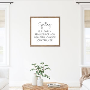 May include: A framed wood sign with a white background and black text that reads "Spring is a lovely reminder of how beautiful change can truly be".