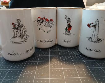 Choice of Merry Masterpieces sets, coffee mugs (4) or dessert plates (4) in the original packaging