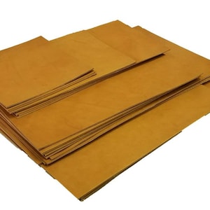 May include: A stack of brown leather sheets, perfect for crafting projects.