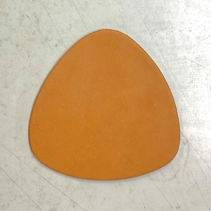 May include: A triangular piece of brown leather.