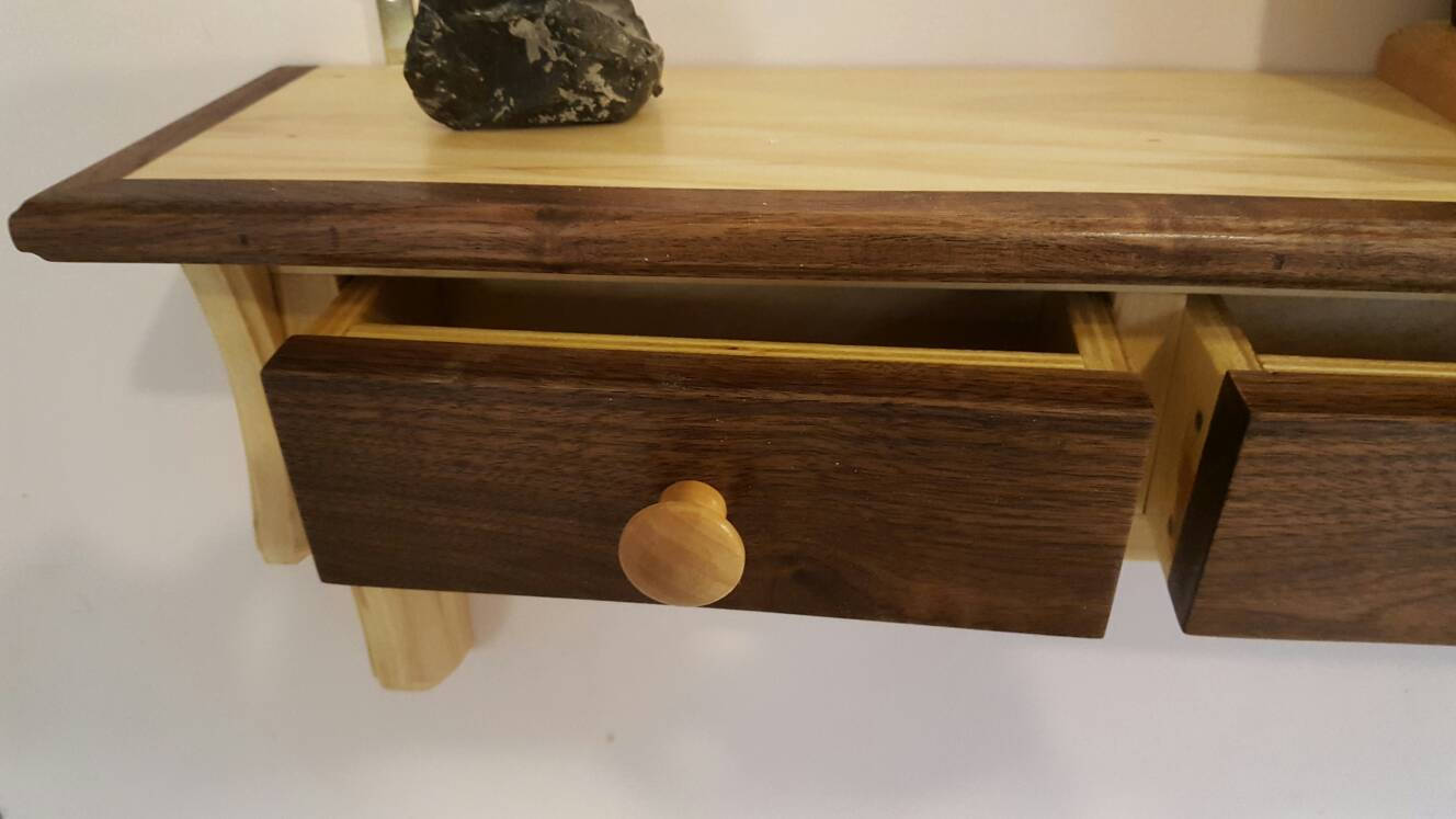 Shelving unit made from walnut and poplar with 3 drawers and 4 pegs