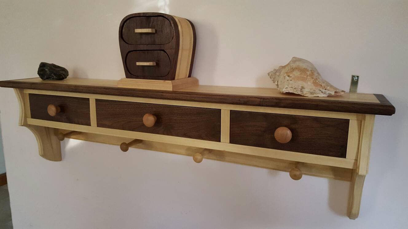 Shelving unit made from walnut and poplar with 3 drawers and 4 pegs