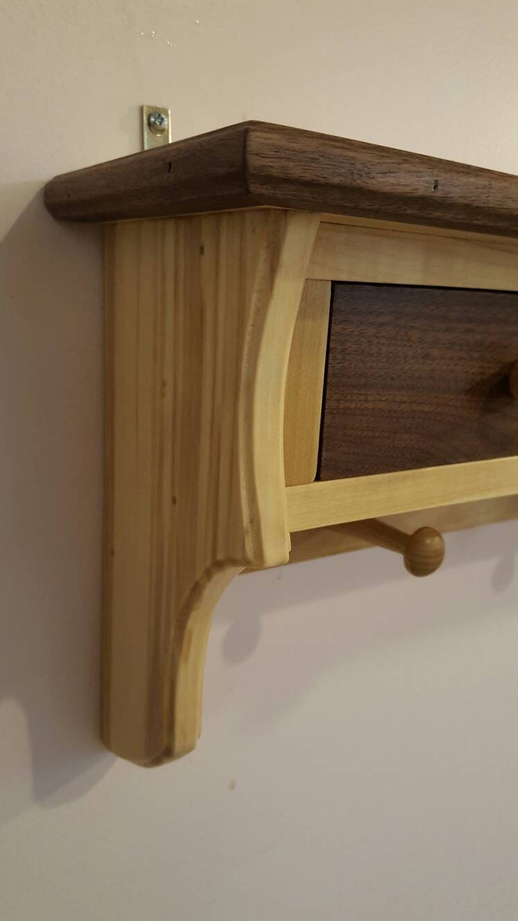 Shelving unit made from walnut and poplar with 3 drawers and 4 pegs