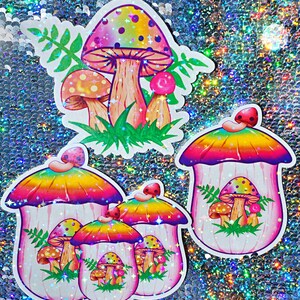 May include: A collection of colorful mushroom stickers with a holographic finish. The stickers feature vibrant designs with rainbow-colored caps, detailed gills, and green grass accents. The stickers vary in size and shape.