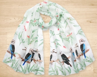 May include: A white silk scarf with a repeating pattern of green leaves, pink flowers, and blue and white birds.