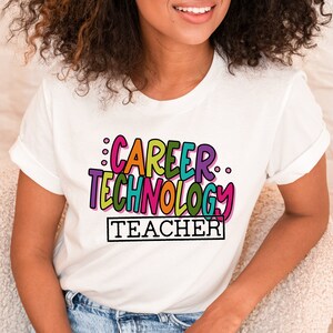 May include: White t-shirt with a colorful graphic that says "Career Technology Teacher" in a playful font.