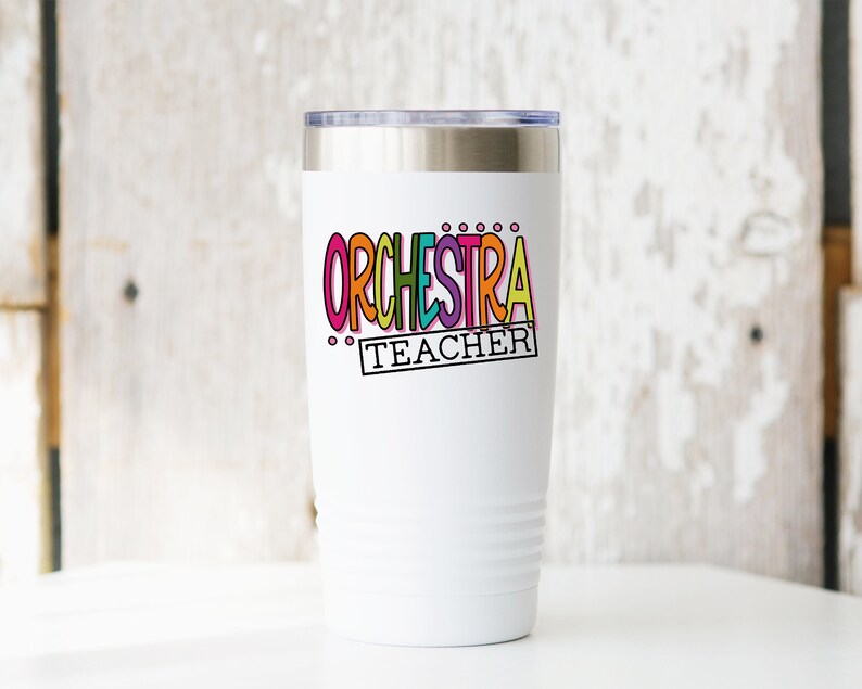 May include: White stainless steel tumbler with a colorful "ORCHESTRA TEACHER" design.