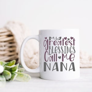 May include: White ceramic mug with a gray and purple design that reads "My greatest blessings call me Nana".