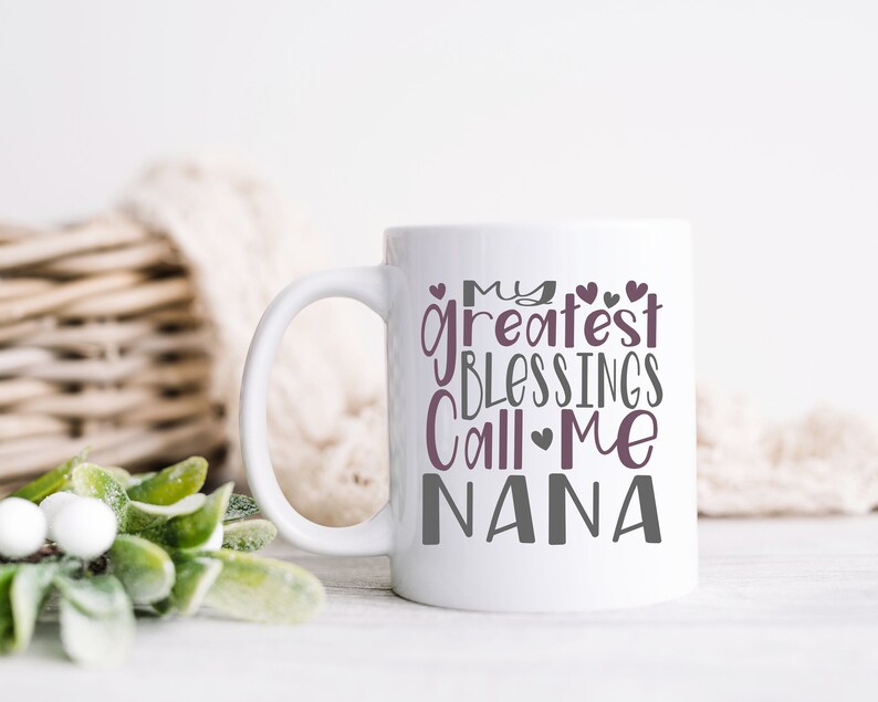 May include: White ceramic mug with a gray and purple design that reads "My greatest blessings call me Nana".