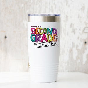 May include: White stainless steel tumbler with a colorful graphic that says "Second Grade: Teacher".