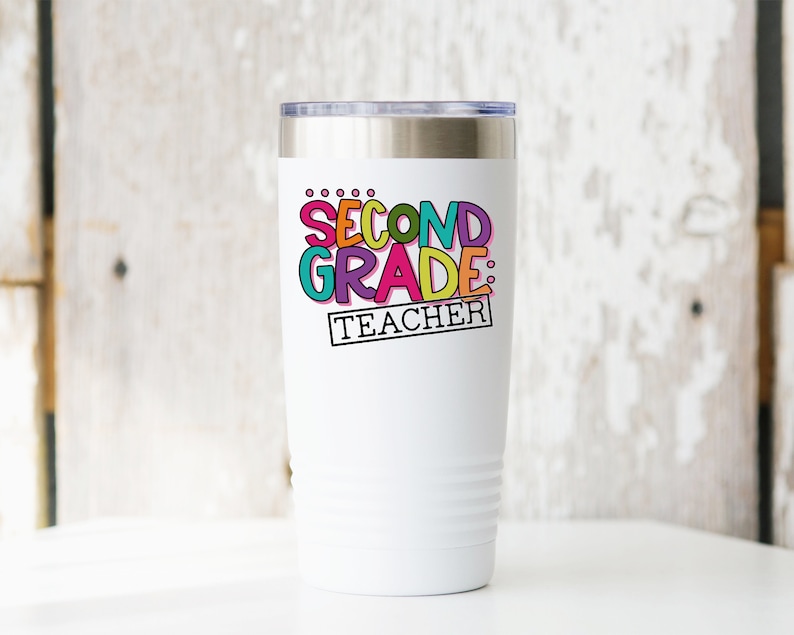May include: White stainless steel tumbler with a colorful graphic that says "Second Grade: Teacher".